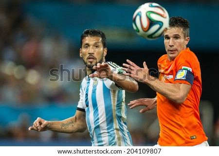 SAO PAULO, BRAZIL - July 9, 2014: GARAY of Argentina and VAN PERSIE of Netherlands compete for the ball during the World Cup Semi-finals game between Netherlands and Argentina at Arena Corinthians.