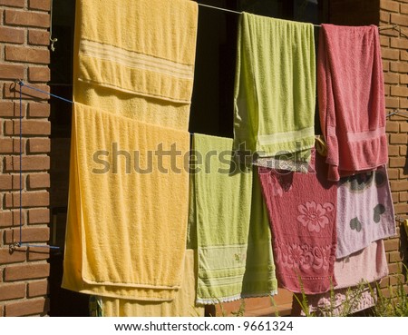 Towel hung in the rope, at the back yard