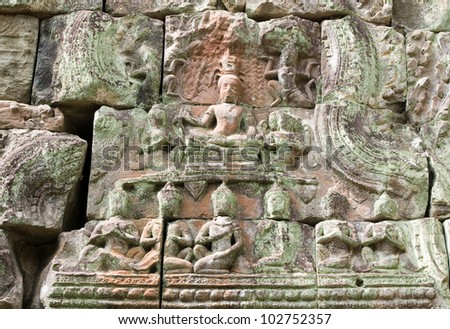 Ancient Khmer bas relief carving of a Buddha, or Bodhisattva figure sitting cross legged in meditation.  Lintel at Preah Khan Temple, Angkor, Cambodia Ancient carving, hundreds of years old.