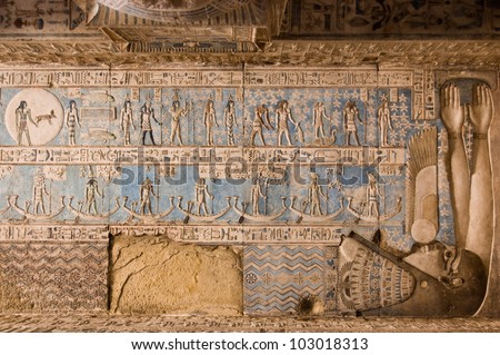 Astrological symbols on the ceiling of Dendera Temple near Qena, Egypt.  The goddess of the night Nut is enclosing the symbols with her body and arms.  Pisces, top left. Carving, over 1000 years old.