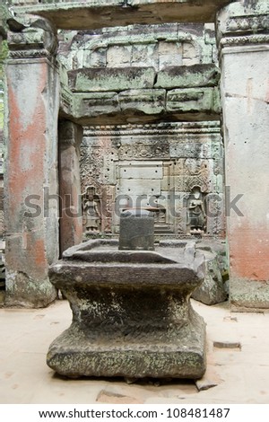 The sacred stone lignum and yoni sculpture in the centre of Preah Khan temple, Angkor, Cambodia.  The cylindrical stone is believed to have male powers, the surrounding, larger stone is female.