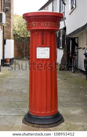 ETON, BERKSHIRE, ENGLAND - MAY 12: Victorian pillar box designed in 1856, Eton, Berkshire on May 12 2012.  The Royal Mail will paint pillar boxes gold to celebrate Olympic medal success this summer.