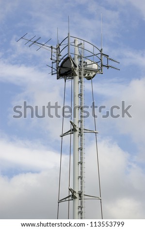 View of a broadcast antenna and aerial tower built to receive microwave and radio signals.