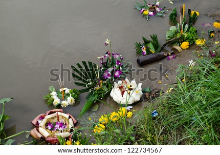 Morning after the festival of Loi Krathong and the floating rafts of offerings are washed up along the banks of the Ping River, Chiang Mai, Thailand.