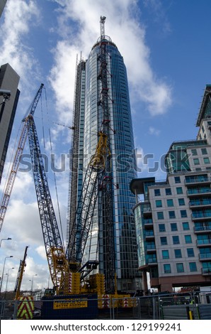 LONDON, ENGLAND - FEBRUARY 5: Construction of St George\'s Wharf Tower continues on February 5 2013, London.  Building work was halted when a helicopter crashed into the main crane.