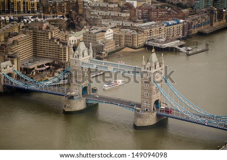 View from a tall building of the landmark Tower Bridge stretching across the River Thames in London.
