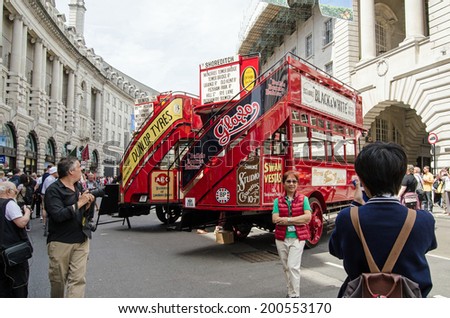 LONDON, ENGLAND - JUNE 22, 2014: Londoners enjoying the cavalcade of historic buses on display along Regent Street, Westminster celebrating the bicentenary of London buses.