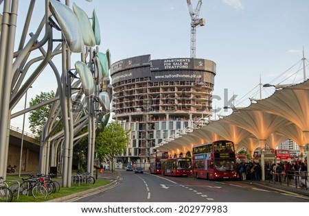 LONDON, ENGLAND - MAY 13, 2014: Passengers getting on buses in the early evening at Stratford in East London.  The town is a busy transport hub in the area.