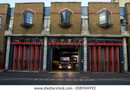 LONDON, UK - JUNE 7, 2014: A fire engine being prepared at Islington Fire Station, London.  The station is part of the London Fire Brigade network of emergency responders.