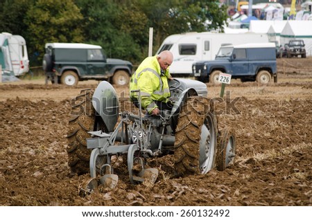 BASINGSTOKE, UK  - OCTOBER 12, 2014: A competitor on a vintage tractor taking part  in the British National Ploughing Championships.  Competing on a vintage Ferguson tractor. Accredited photographer