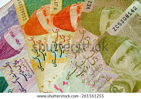 A cab of Pakistan rupee banknotes of different denominations.  The Father of the Nation - Muhammad Ali Jinnah shown wearing a hat known as a karakul. Used banknotes, less than 80% displayed.