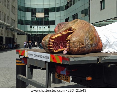 LONDON, UK - JUNE 1, 2015:  A life size model of a dead tyrannosaurus promoting the National Geographic Channel\'s T Rex Autopsy programme outside the BBC headquarters in Westminster, London.