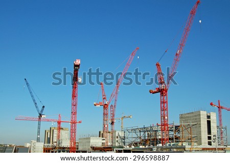 LONDON, UK - AUGUST 25, 2007: A forest of construction cranes building the huge Westfield Shopping Centre at Shepherd\'s Bush in West London. View on a sunny afternoon in August.