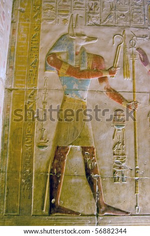 Ancient Egyptian god Anubis Depicted with the head of a jackal, Anubis is the god of mummification.  Temple to Osiris at Abydos, Egypt.