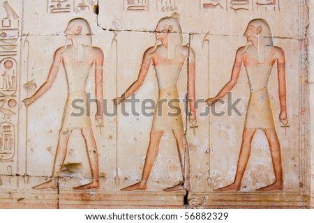 Three ancient egyptian priests A trio of ancient egyptian priests carved and painted on the side of a wall of the Temple of Ramses at Abydos, Egypt.