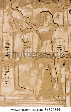 Ancient Egyptian hieroglyphic carving of Ramses II with the creator god Ptah.   Temple of Medinet Habu on the west bank of the Nile at Luxor, Egypt.