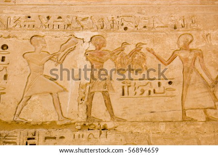 Ancient Egyptian Duck Dinner Two ducks or geese being offered to the gods.  Ancient Egyptian carving on a wall of the temple of Medinet Habu on the west bank of the Nile at Luxor, Egypt.