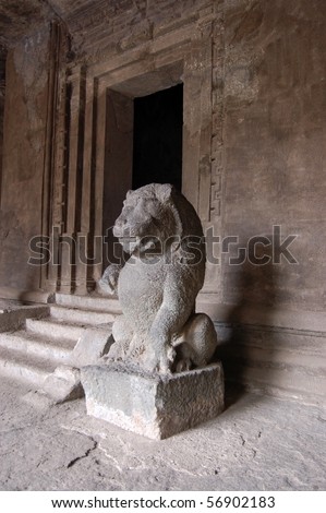 Lion statue, Hindu temple, Elephanta caves A large stone statue of a lion guarding one of the ancient Hindu temples in the caves on Elephanta Island off the coast of Mumbai, formerly Bombay, India.