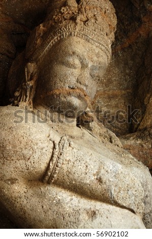 Shiva carving An ancient carving of the Hindu god Shiva.  This huge statue is inside the cave temples on the island of Elephanta off the coast of Mumbai (formerly Bombay), India.
