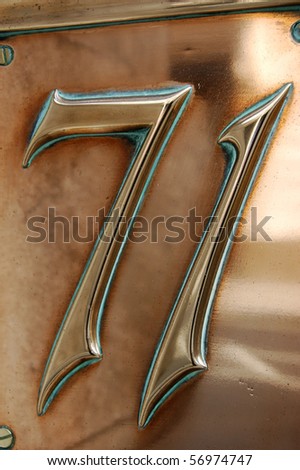 Seventy One The number \'seventy one\' (71) embossed on a copper plate and on public display on the outside of an early victorian building in the City of London.