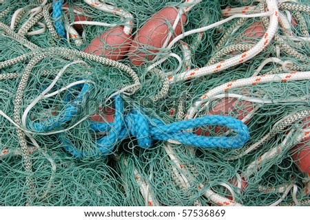 Fishing nets and rope a messy pile of fishing net, ropes and floats drying in the sunshine at Mudeford Quay in Dorset