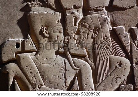 Ancient Egyptian Embrace Pharaoh Ramses and Queen Nefertiti embracing each other.  Carved in stone at the Temple of Karnak in Luxor, Egypt.