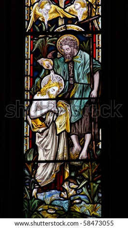 John the Baptist stained glass window A Victorian stained glass window depicting John the Baptist pouring holy water on the head of Jesus Christ.
