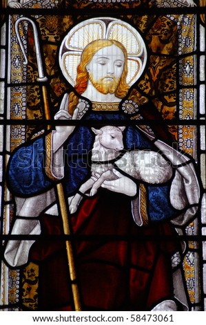 Christ and lamb A Victorian stained glass window depicting Jesus Christ with a shepherd\'s crook and a lamb.