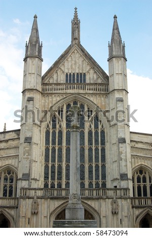 Winchester Cathedral viewed from the West View of the impressive Western facade of Winchester Cathedral in Hampshire.  The column before the facade is a war memorial.