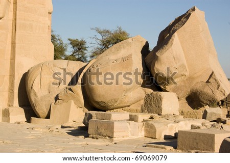 The toppled giant statue of the ancient Egyptian Pharaoh Ramses II which inspired the poet Shelley to wrote his poem Ozymandias.  Ramesseum Temple, Luxor, Egypt.