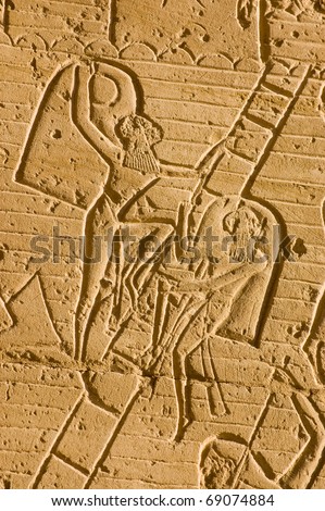 Ancient Egyptian Soldiers using shields and a ladder to fight against the Hittites in the Battle of Kadesh.  Stone carved frieze on the second pylon of the Ramesseum Temple, Luxor, Egypt.