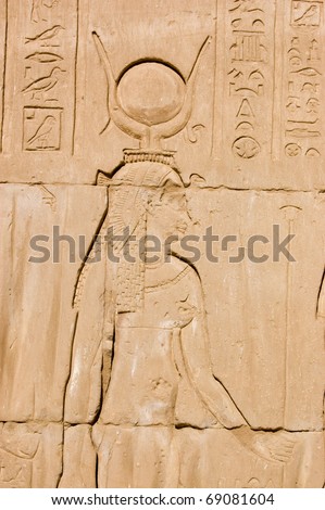 Ancient Egyptian carving of the goddess Hathor with her typical crown of cow horns.  Wall at the Temple of Horus at Edfu, Egypt.