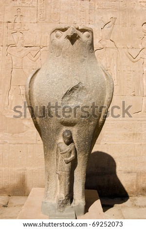 Ancient egyptian granite statue of the falcon headed god Horus protecting the Pharaoh.  Temple of Horus, Edfu, Egypt.
