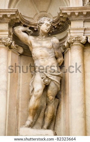 Statue of a male nude representing a human virtue. Facade of the Scalzi church in the Cannaregio district of Venice, Italy.