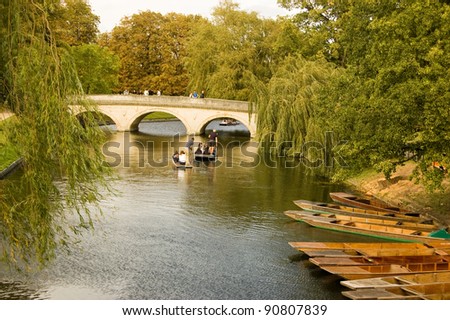 CAMBRIDGE, ENGLAND - SEPTEMBER 19: University students punting along the River Cam in Cambridge on September 19 2011.  Competition to rent the small wooden boats has become particularly fierce.