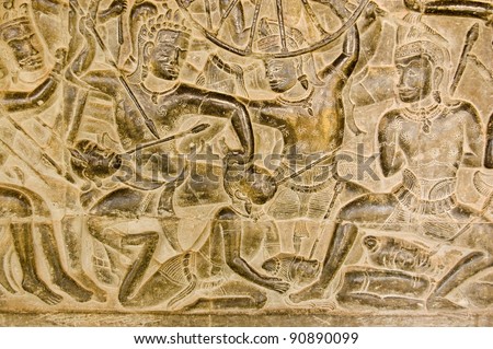 An ancient Khmer carving of the Battle of Kurukshetra showing a man being killed as described in the Mahabharata.  Bas Relief, Angkor Wat Temple, Siem Reap, Cambodia.