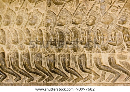 Bas relief of Pandava soldiers marching to the Battle of Kurukshetra as described in the Mahabharata.  Eleventh century carving, wall of Angkor Wat temple, Siem Reap, Cambodia.