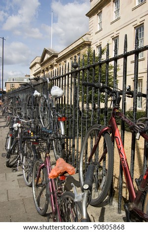 CAMBRIDGE, ENGLAND - SEPTEMBER 19: Student bicycles chained to railings outside Emmanuel College on September 19 2011.  The City is one of the most bicycle friendly in the country.