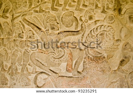 A warrior armed with a sword in battle while riding a Chinese lion.  Bas relief carving in the Vishnu and the Asuras gallery, Angkor Wat temple, Siem Reap, Cambodia.