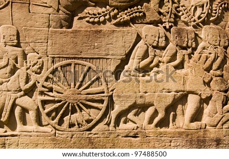 An ancient Khmer carving of a cart pulled by a cow.  Wall of Bayon Temple, Angkor Thom, Siem Reap, Cambodia.