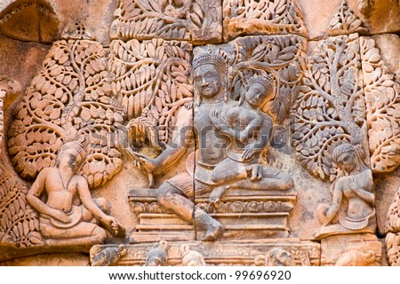 Ancient Khmer bas relief carving showing the Hindu gods Shiva and Uma sitting on Mount Kailas.  Banteay Srei Temple, Angkor, Cambodia.