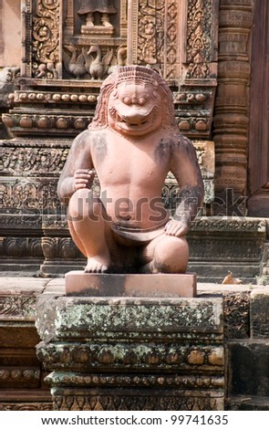 Ancient Khmer statue of a temple guardian, half lion, half man.  Banteay Srei Temple, Angkor, Cambodia.