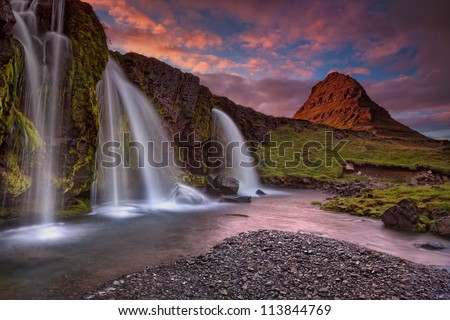 Extinct volcano in Iceland (Island). Sunset at Mount Kirkjufell (Church mountain) in the Snaefellsnes peninsula, Iceland, complimented by a beautiful waterfall.
