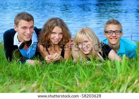 The youth group has a rest on river bank