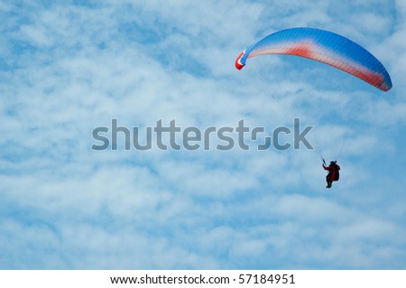 Paragliding is air sport. The pilot sits in a harness under tissue wing and flying.
