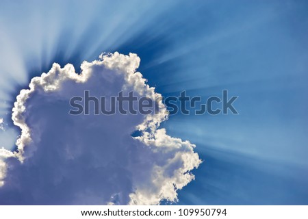 Fantastic sun rays are striking through the clouds like an explosion