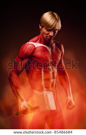 Fine art portrait of angry muscular man. Bodyart \