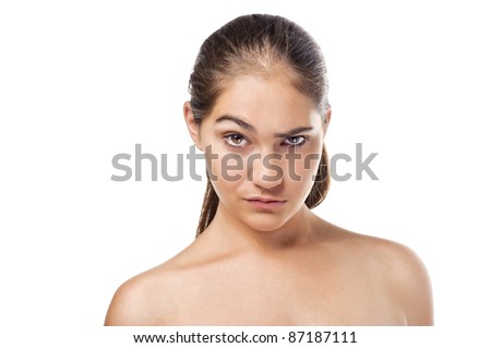 Closeup portrait of a serious beautiful woman raising an eyebrow - isolated on white background