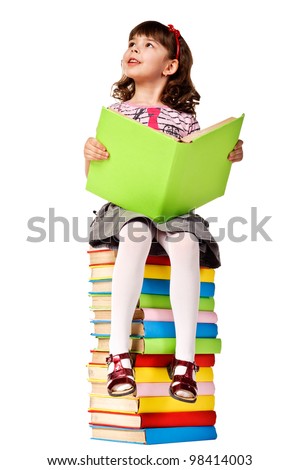 Little girl sitting on stack of books. Isolated over white