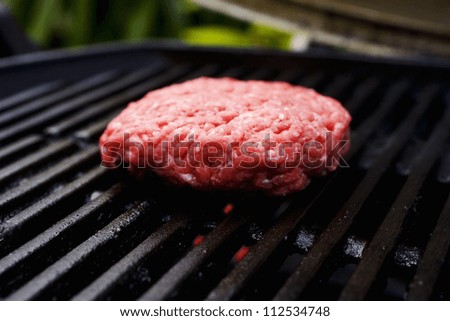 Barbecue scene, hamburger patty on the grill